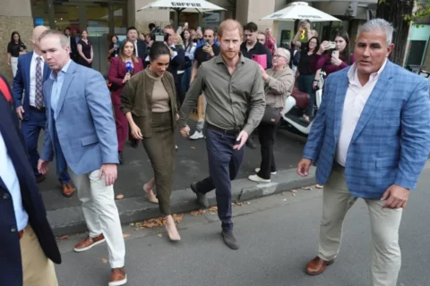 El operativo de seguridad rodeó a Harry y Meghan a su salida del Museo Nacional de Arte de Veteranos de Australia en Melbourne, Australia, el 14 de abril. Jonathan Brady/AFP/Getty Images