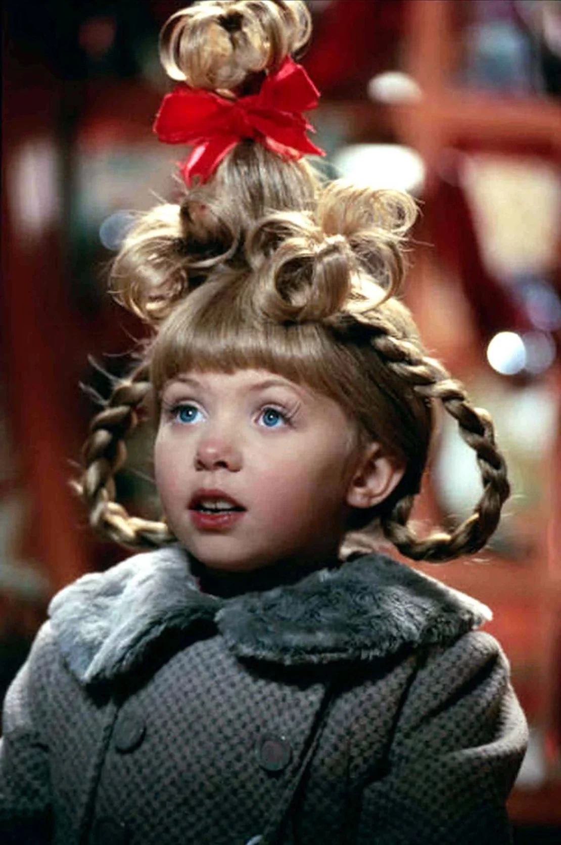 Rizos, trenzas y una cola de caballo que llevó el "recogido" a nuevas alturas, literalmente: este peinado para el personaje de Taylor Momsen, Cindy Lou, que lo tenía todo. AJ Pics/Alamy Stock Photo