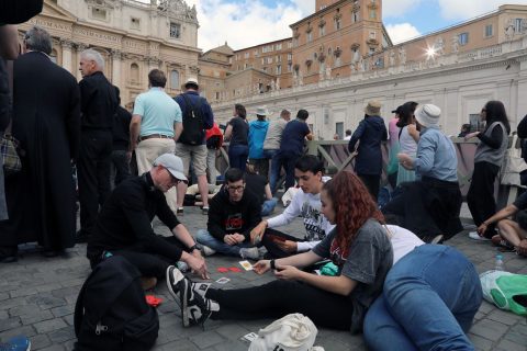 Jugando cartas, tomando helado y comprando recuerdos: Personas pasan el tiempo en Plaza de San Pedro esperando el humo blanco